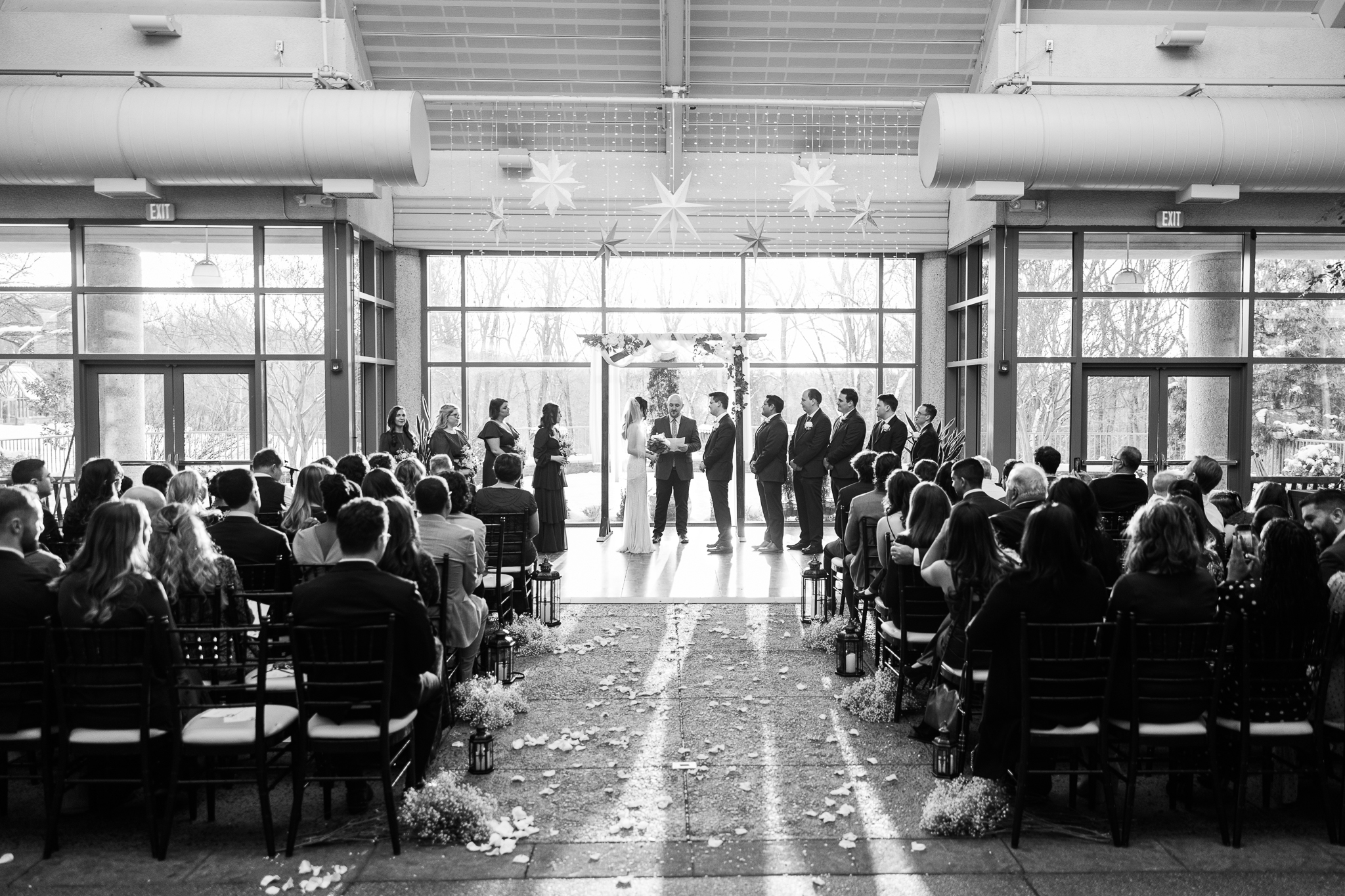 A wedding ceremony happening inside of The Atrium at Meadowlark in Vienna, VA